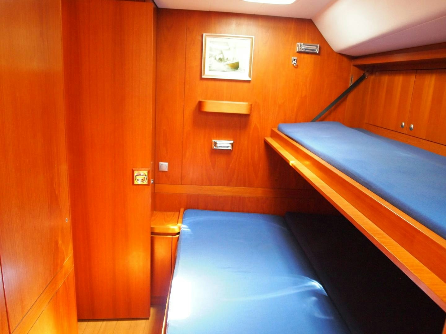 a room with a bed and a wood door aboard enigma viii Yacht for Sale