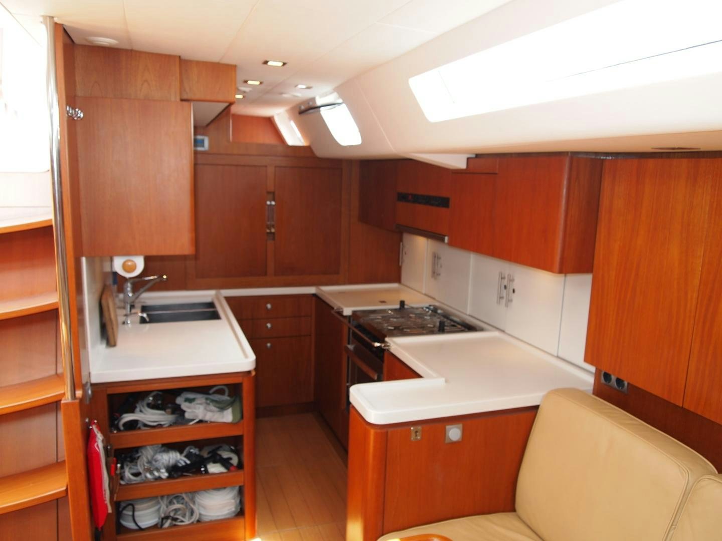 a kitchen with wooden cabinets aboard enigma viii Yacht for Sale