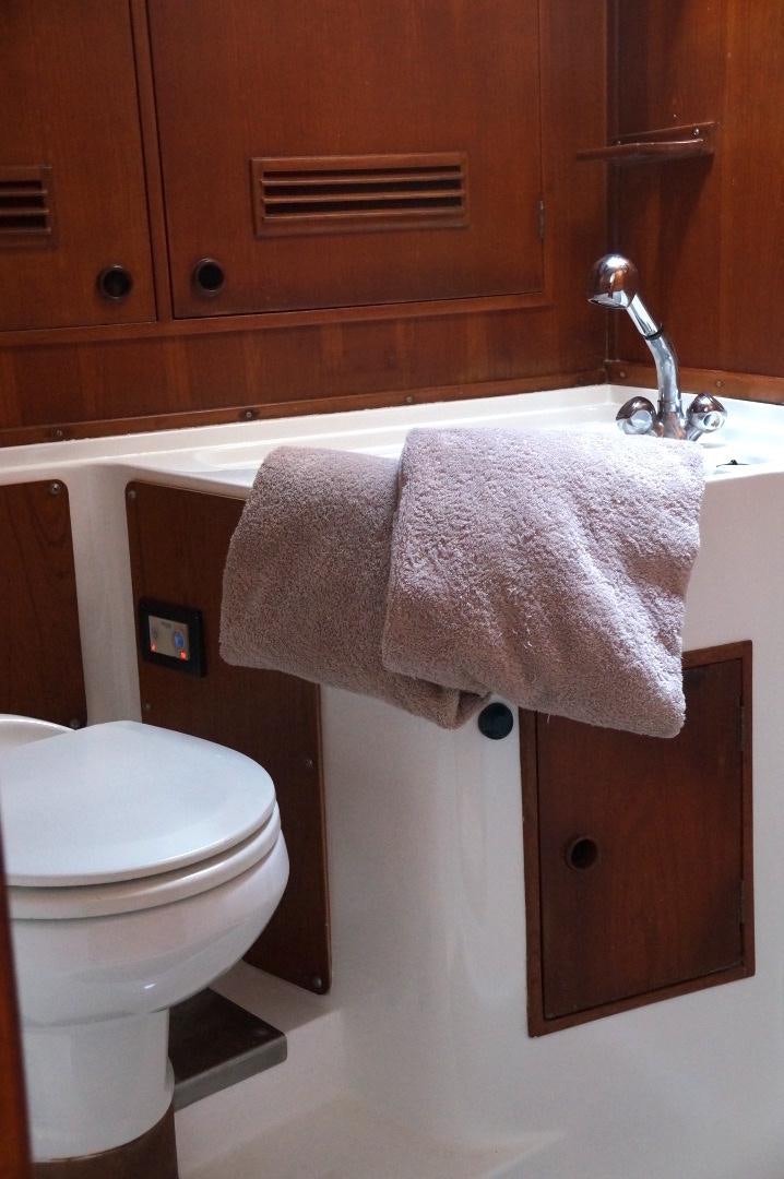 a bathroom with a toilet and a sink aboard kings legend Yacht for Sale