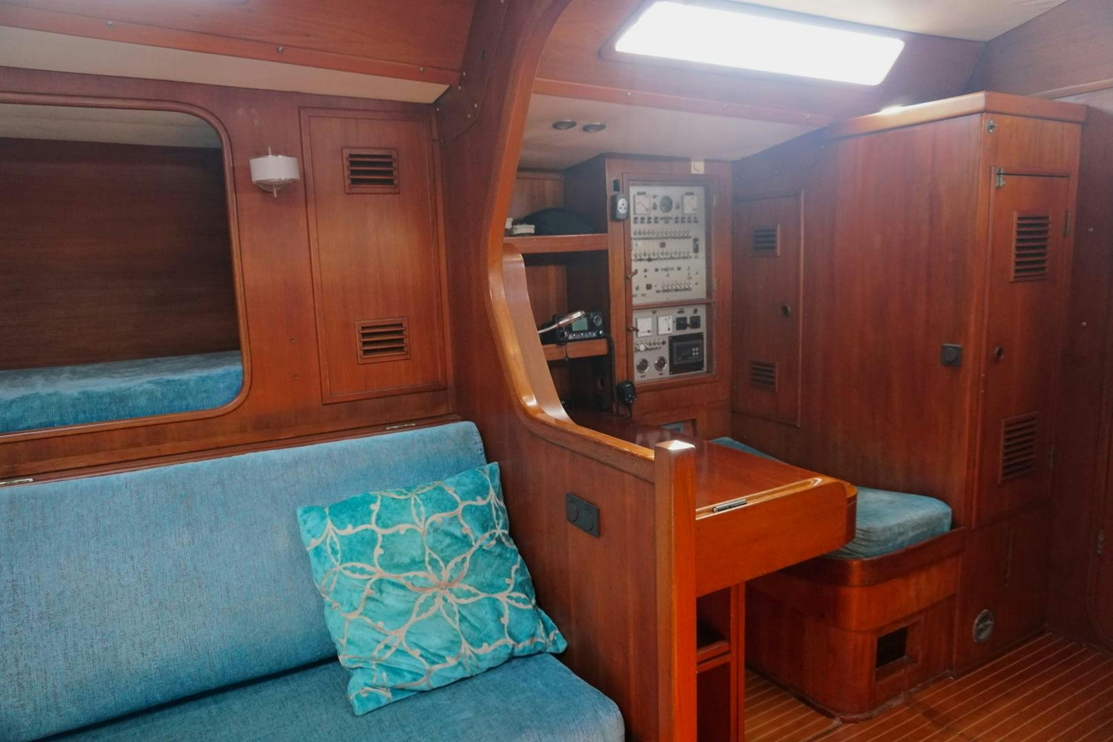 a cabin with a bed and desk aboard kings legend Yacht for Sale