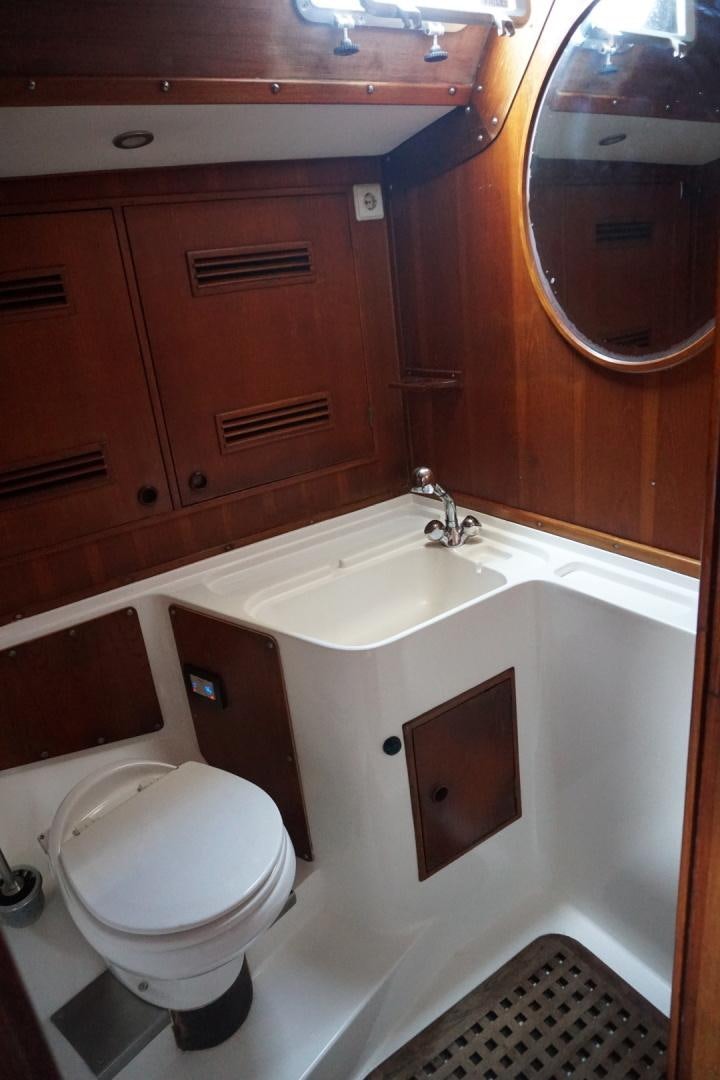 a bathroom with a toilet and a sink aboard kings legend Yacht for Sale
