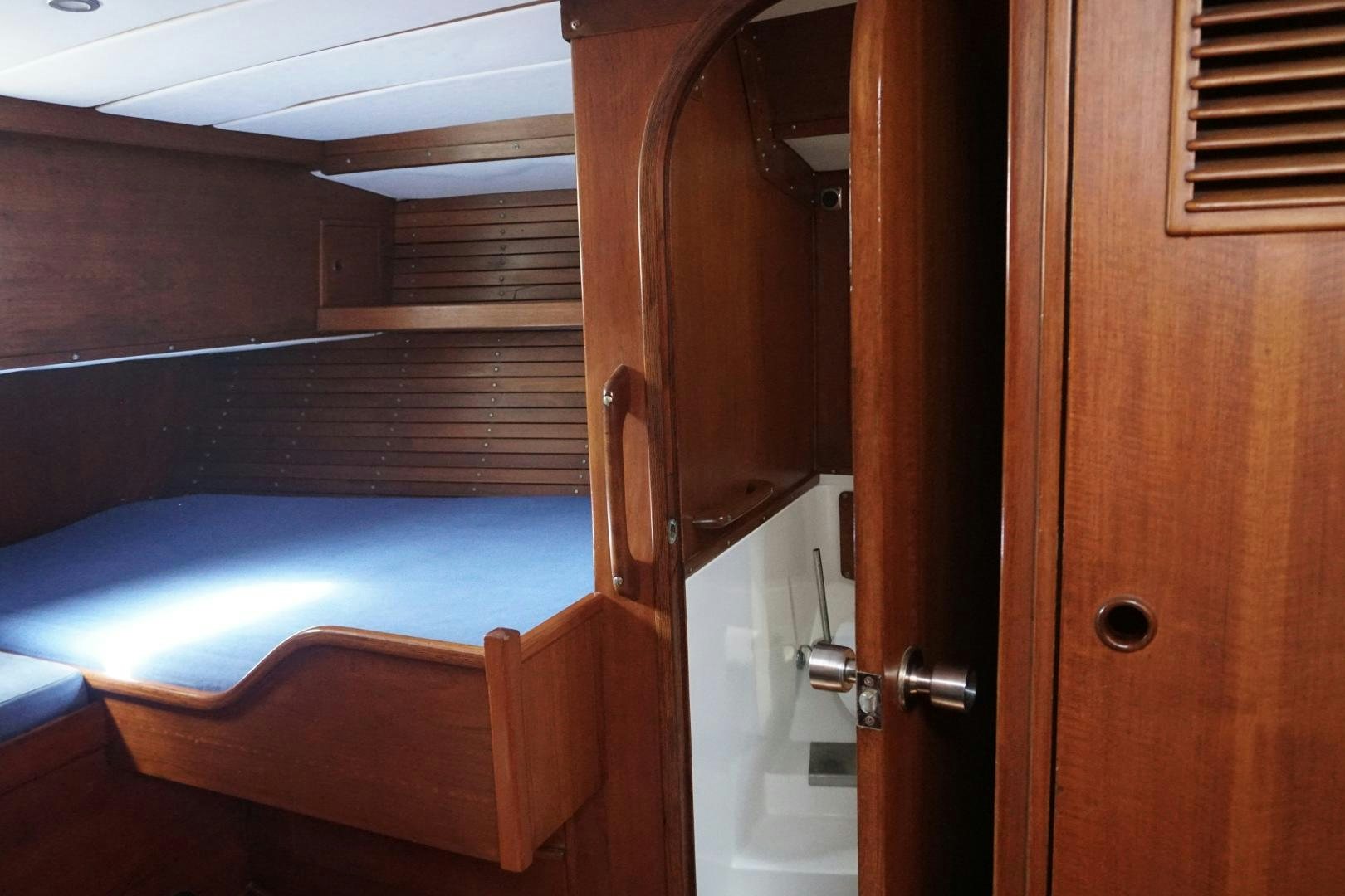 a room with a bed and a closet aboard kings legend Yacht for Sale