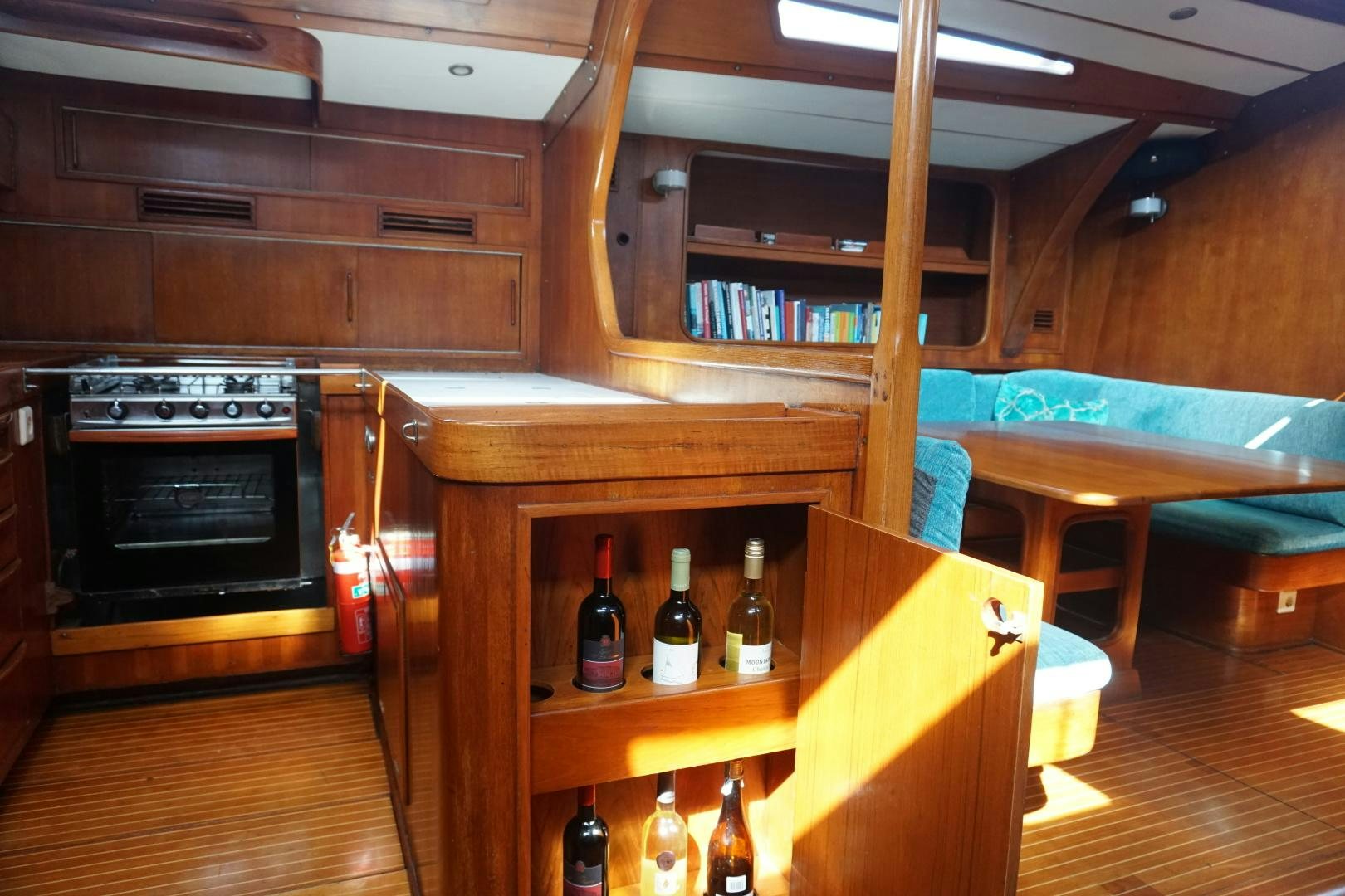 a wooden kitchen with a few bottles of wine aboard kings legend Yacht for Sale