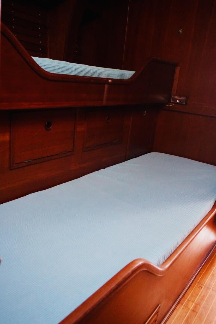 a bed with a white sheet aboard kings legend Yacht for Sale