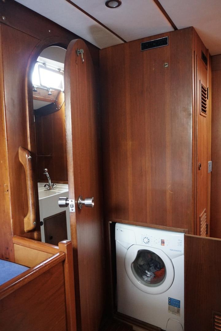 a washer and dryer in a bathroom aboard kings legend Yacht for Sale