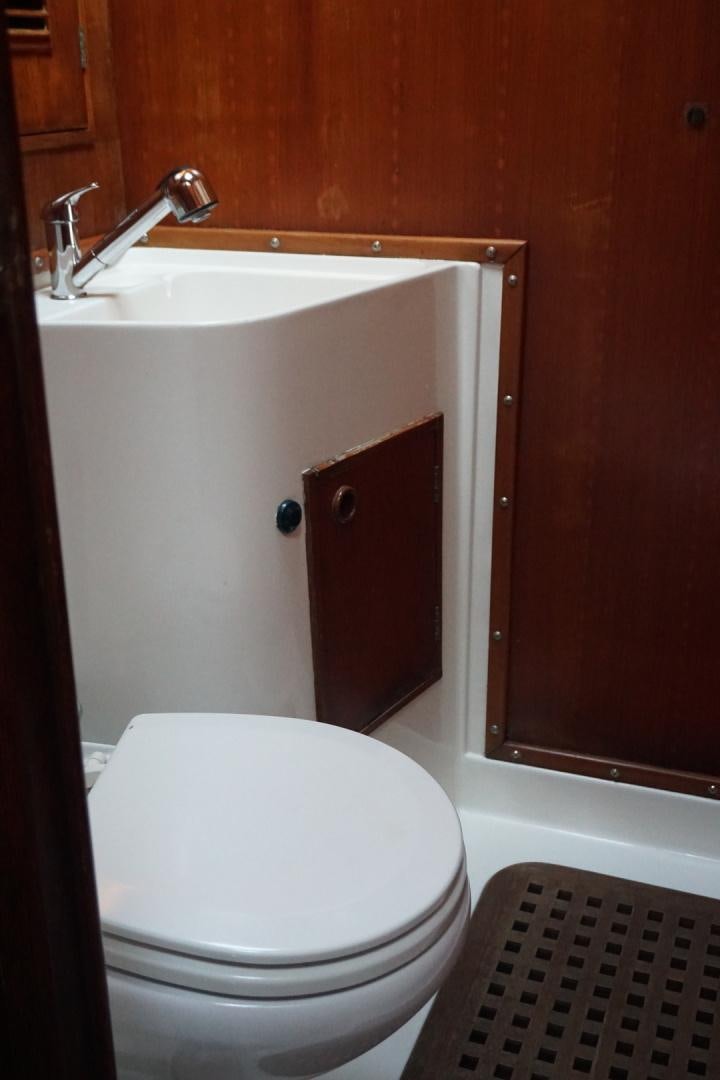 a bathroom with a toilet and sink aboard kings legend Yacht for Sale