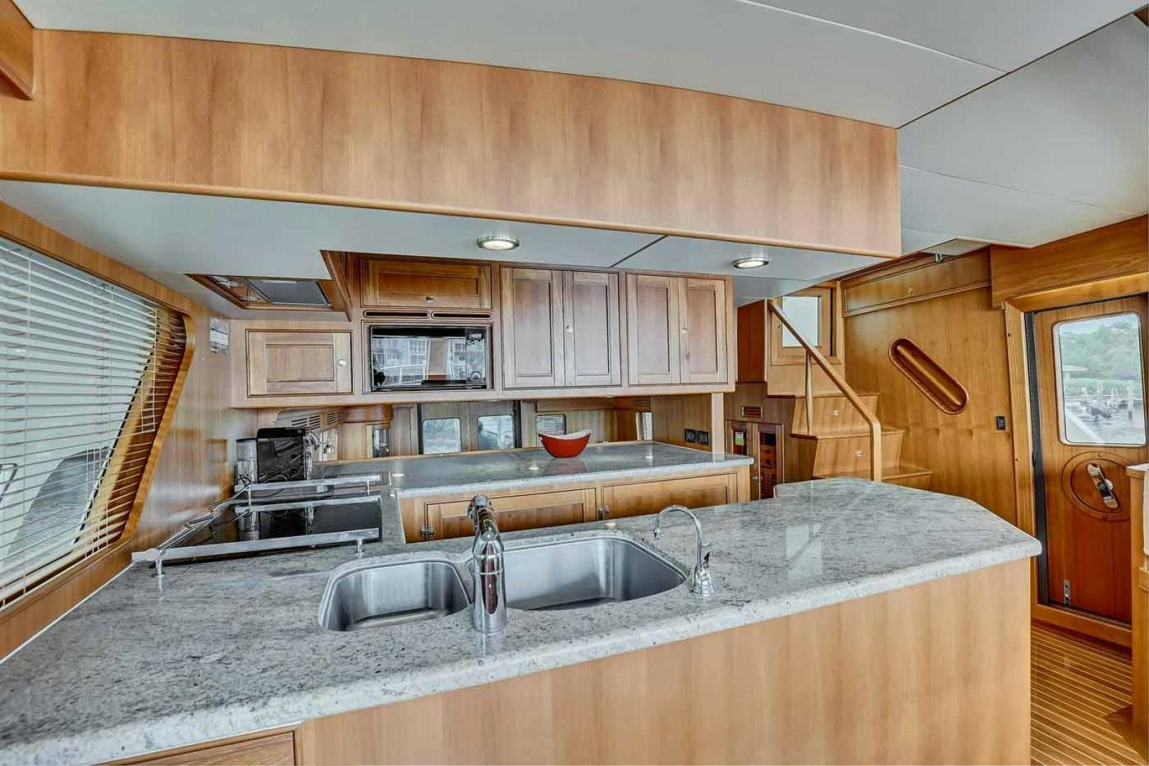a kitchen with wooden cabinets aboard MEGUSTA Yacht for Sale