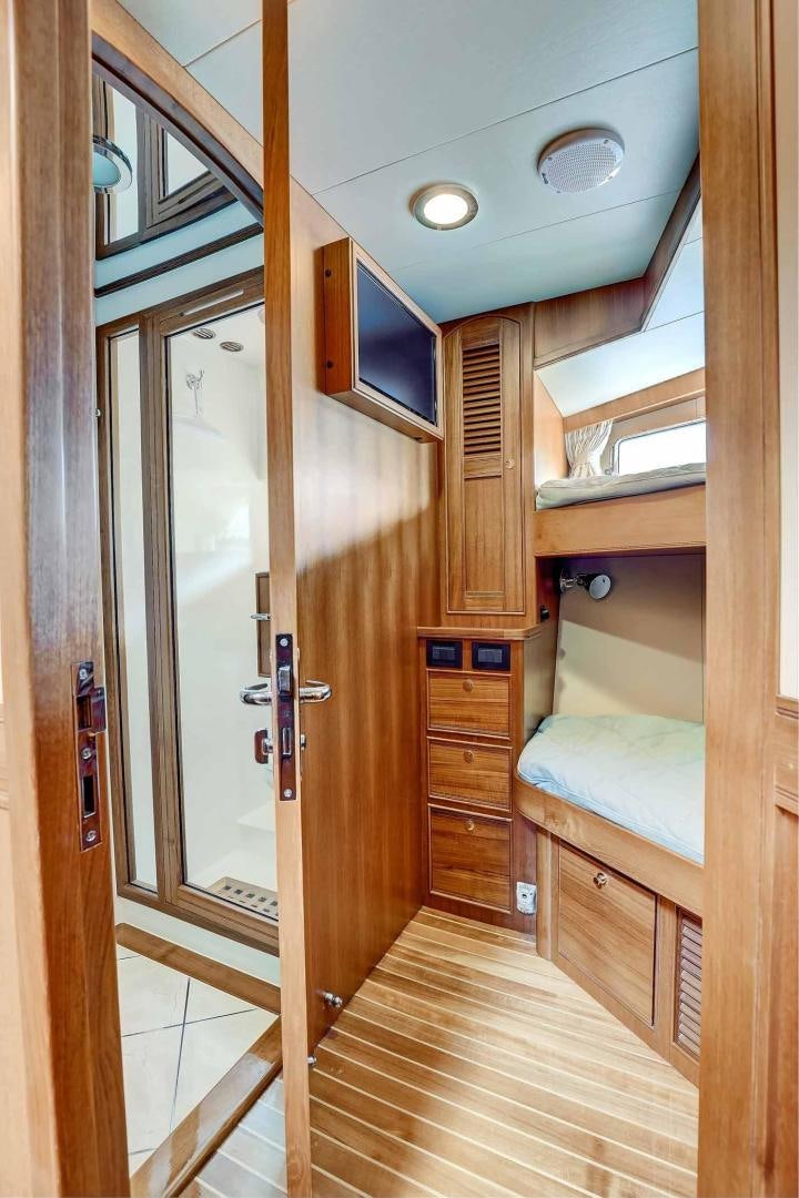 a room with a bed and a closet aboard MEGUSTA Yacht for Sale