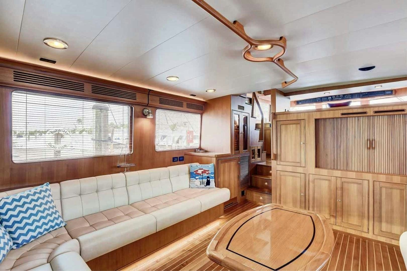 a living room with a couch and a wood floor aboard MEGUSTA Yacht for Sale