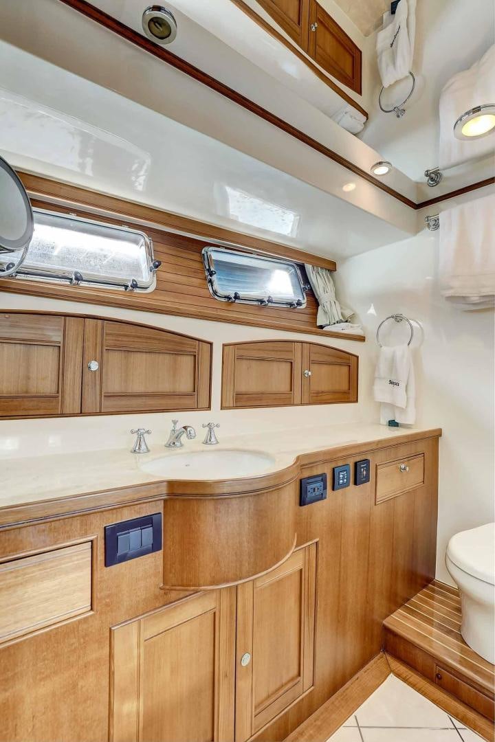 a bathroom with wooden cabinets aboard MEGUSTA Yacht for Sale