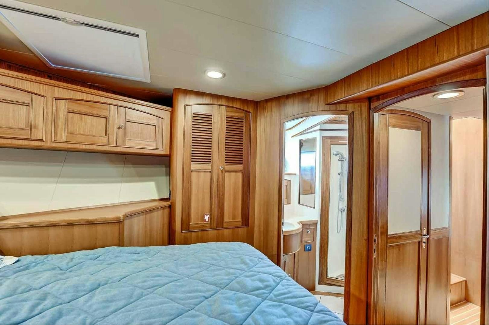 a bedroom with wooden cabinets aboard MEGUSTA Yacht for Sale