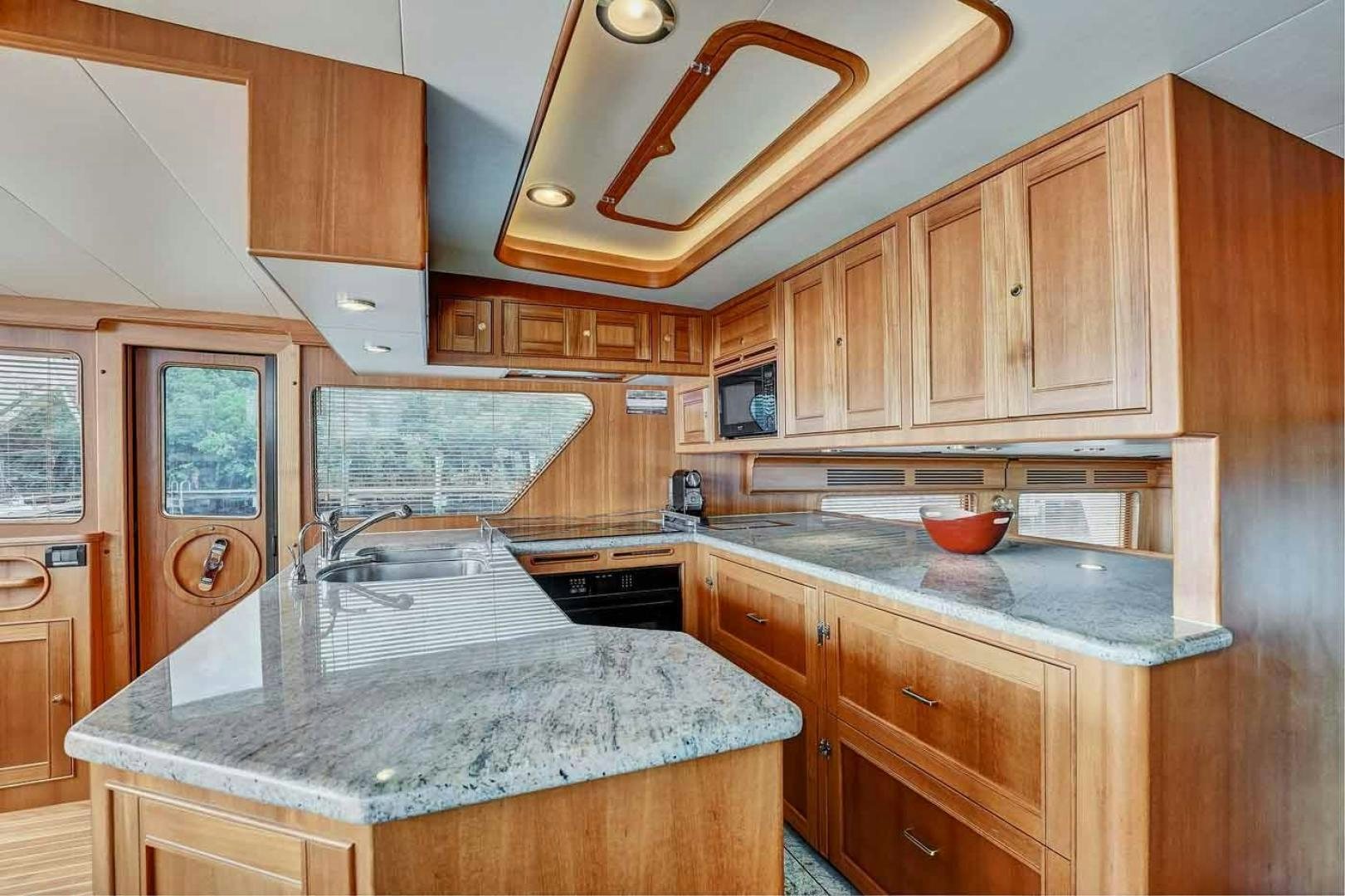 a kitchen with wooden cabinets aboard MEGUSTA Yacht for Sale