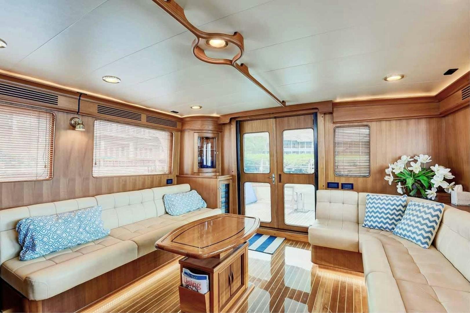 a living room with a couch and a table aboard MEGUSTA Yacht for Sale