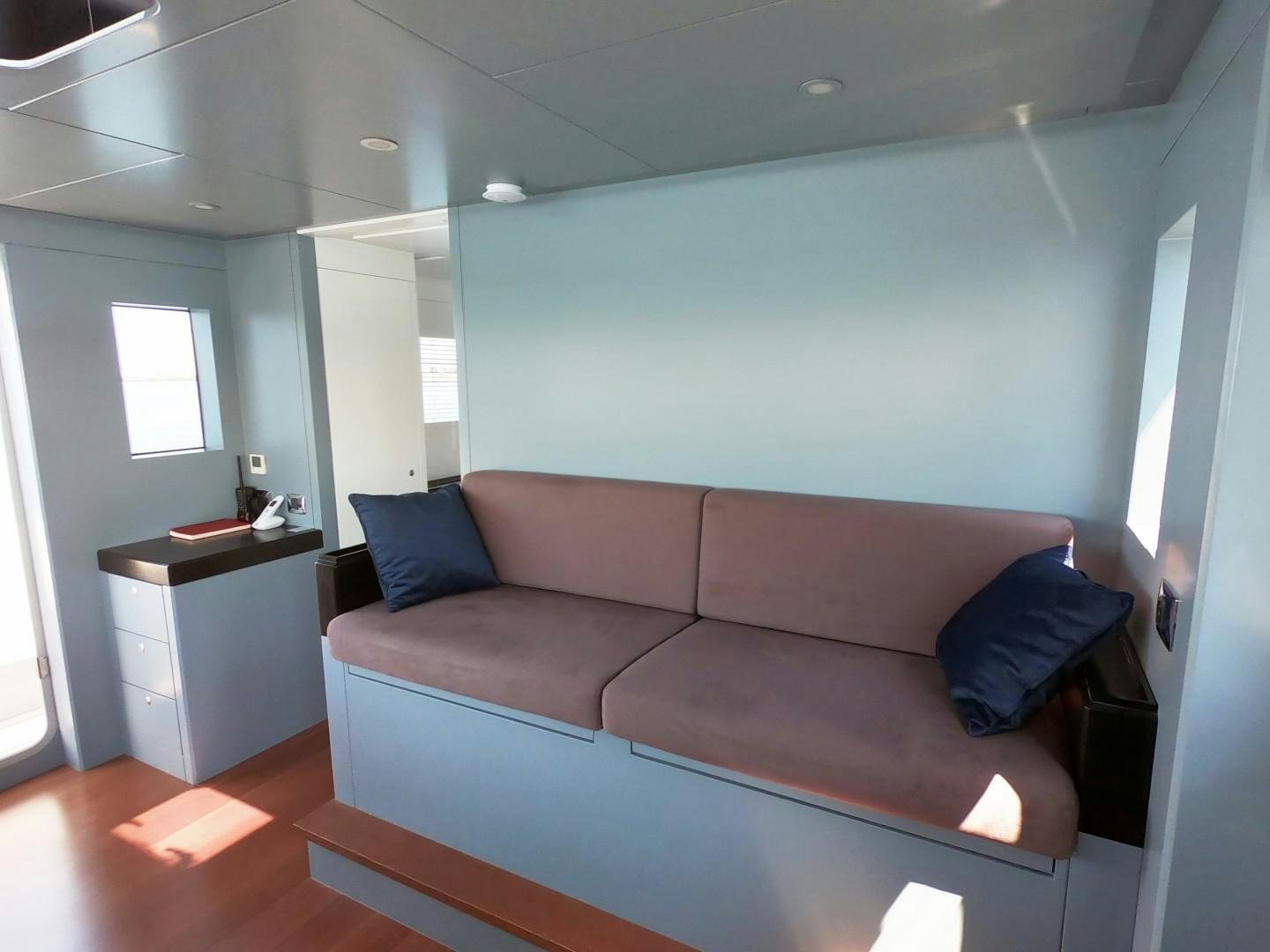 a couch in a room aboard MUZO'S 20 Yacht for Sale