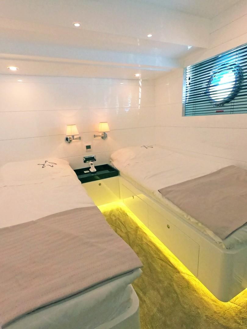 a room with two beds aboard MUZO'S 20 Yacht for Sale