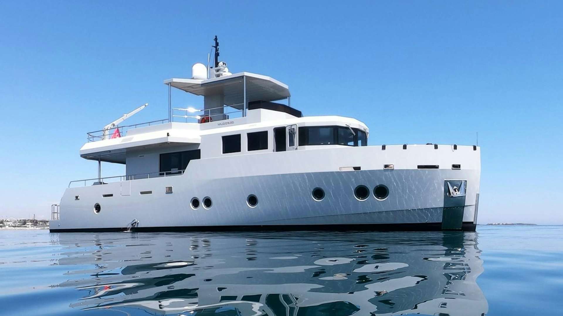a white boat in the water aboard MUZO'S 20 Yacht for Sale