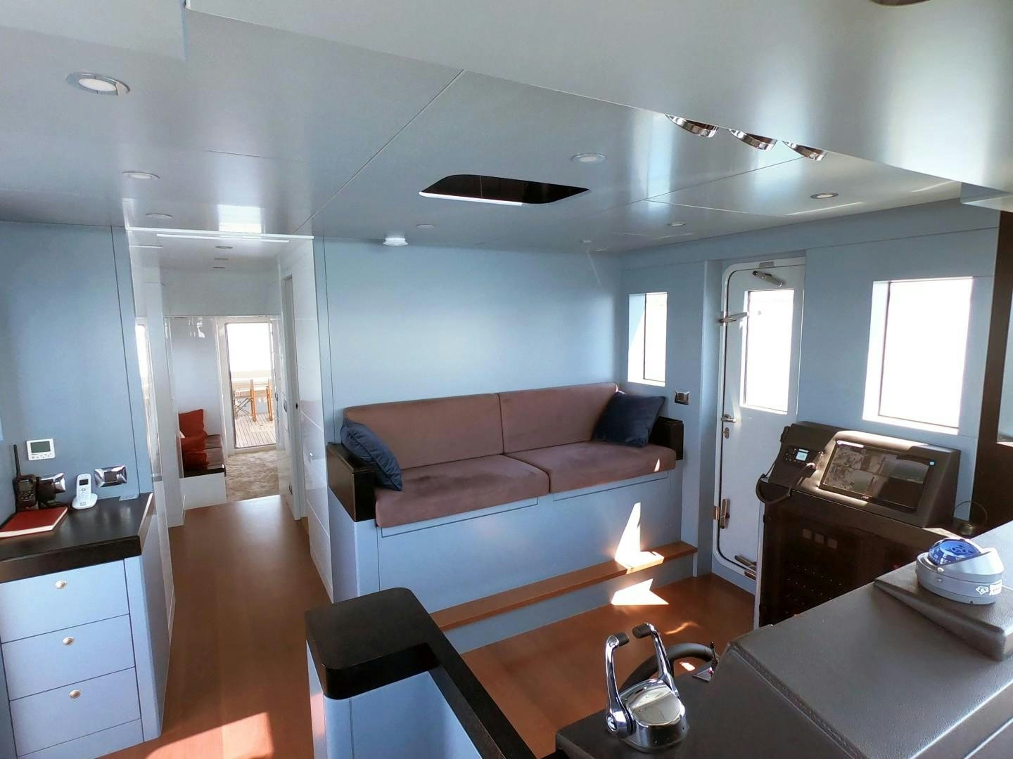 a living room with a couch and a table aboard MUZO'S 20 Yacht for Sale