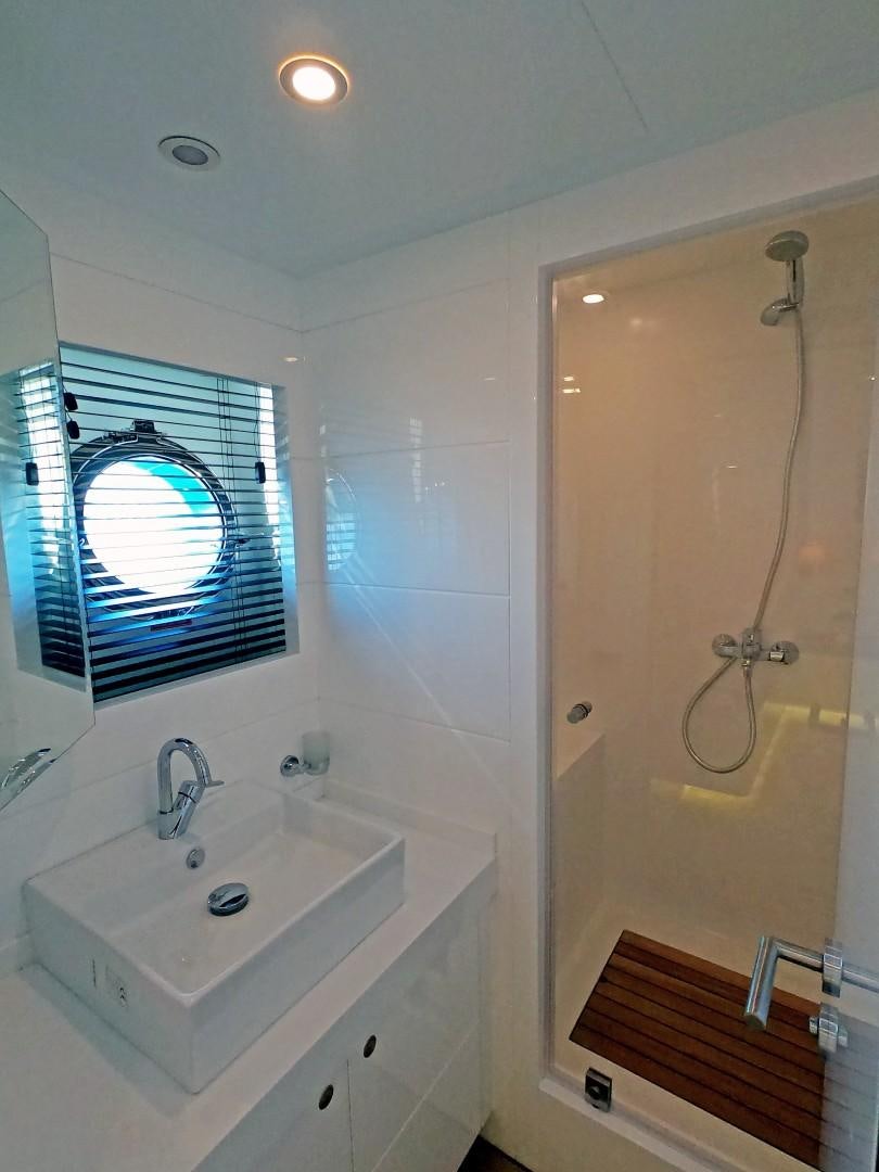 a bathroom with a sink and a shower aboard MUZO'S 20 Yacht for Sale