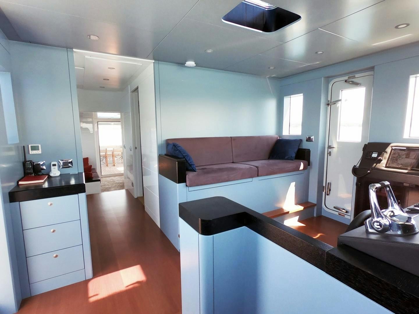 a living room with a couch and a table aboard MUZO'S 20 Yacht for Sale