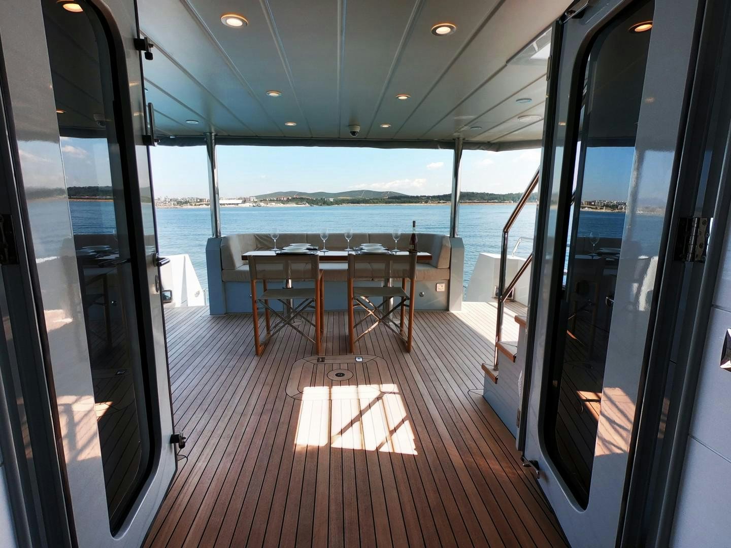 a room with a table and chairs aboard MUZO'S 20 Yacht for Sale