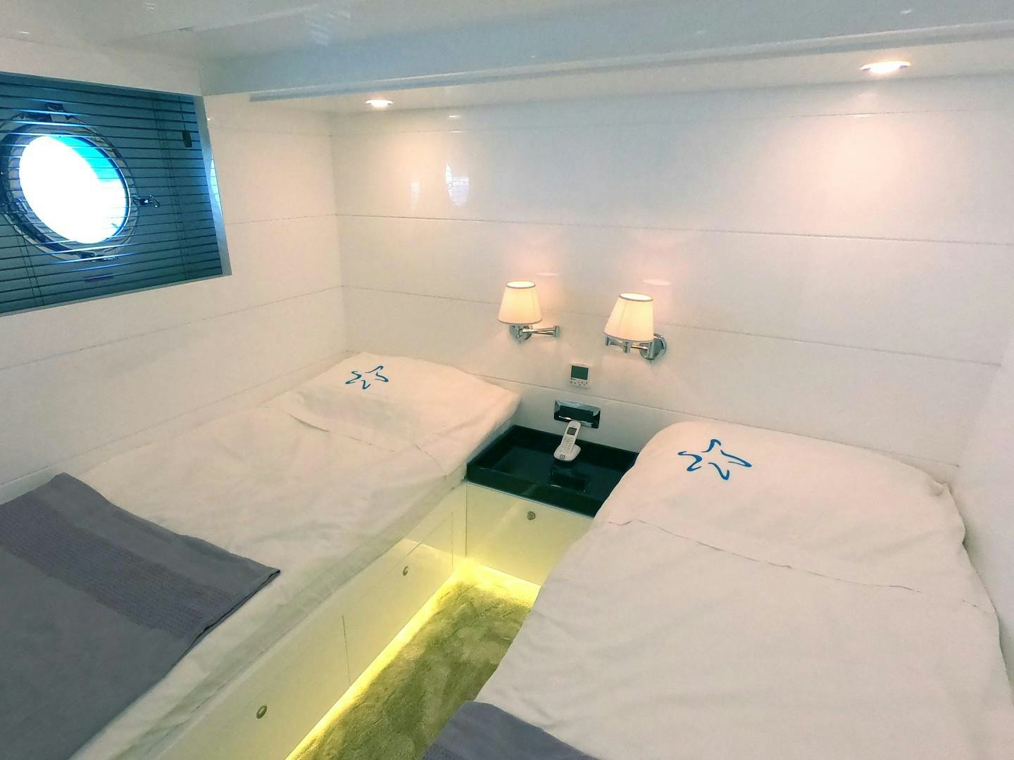 a room with two beds aboard MUZO'S 20 Yacht for Sale