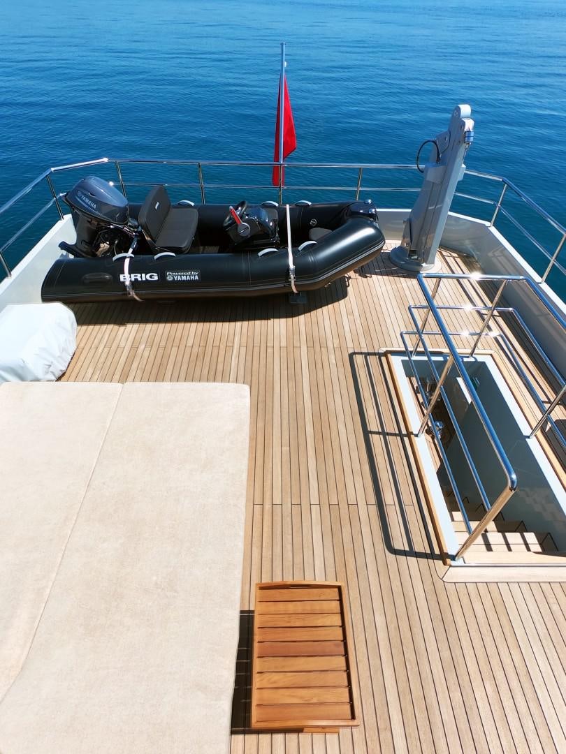 a black go kart on a wooden deck by the water aboard MUZO'S 20 Yacht for Sale
