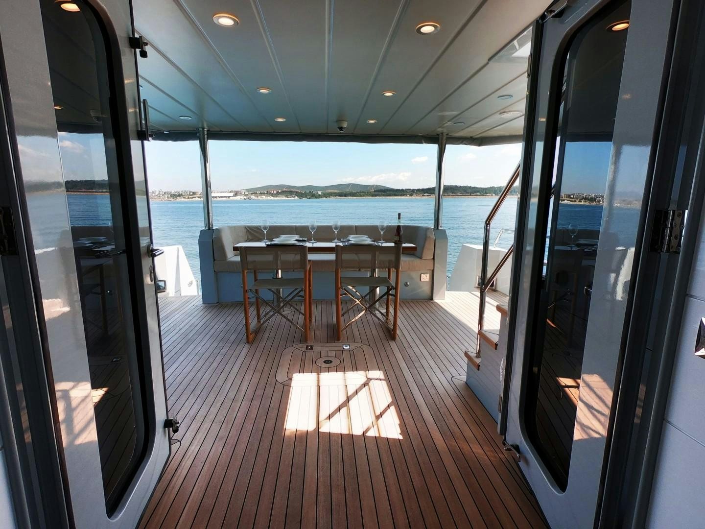 a room with a table and chairs aboard MUZO'S 20 Yacht for Sale