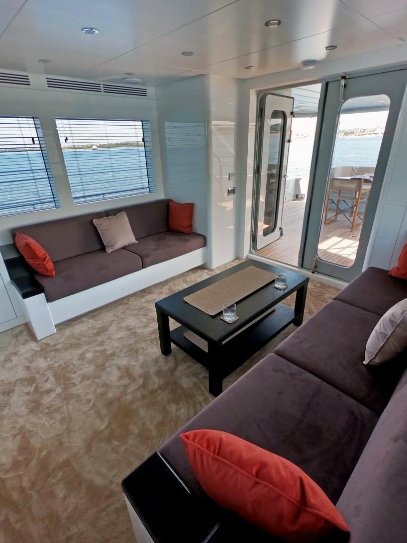 a living room with a couch and a coffee table aboard MUZO'S 20 Yacht for Sale