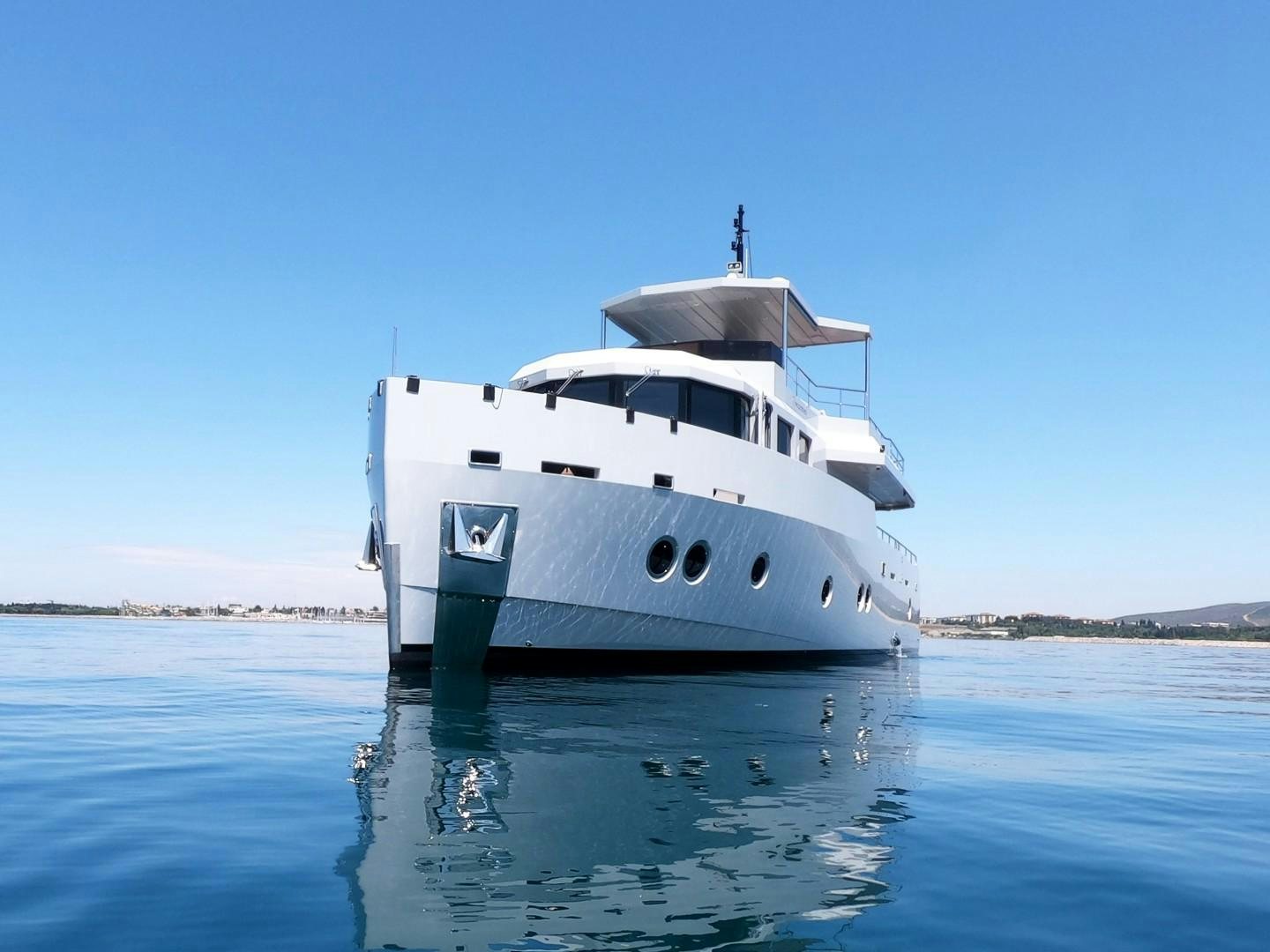 a white boat in the water aboard MUZO'S 20 Yacht for Sale