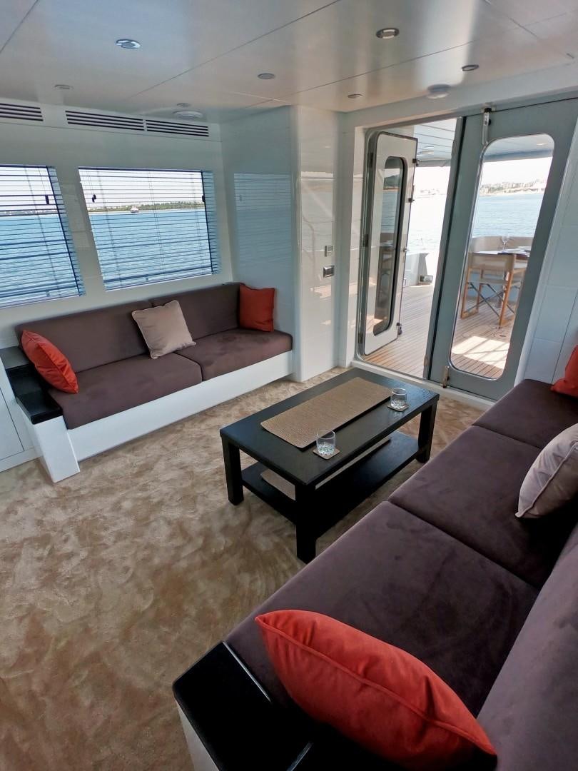 a living room with a couch and a coffee table aboard MUZO'S 20 Yacht for Sale