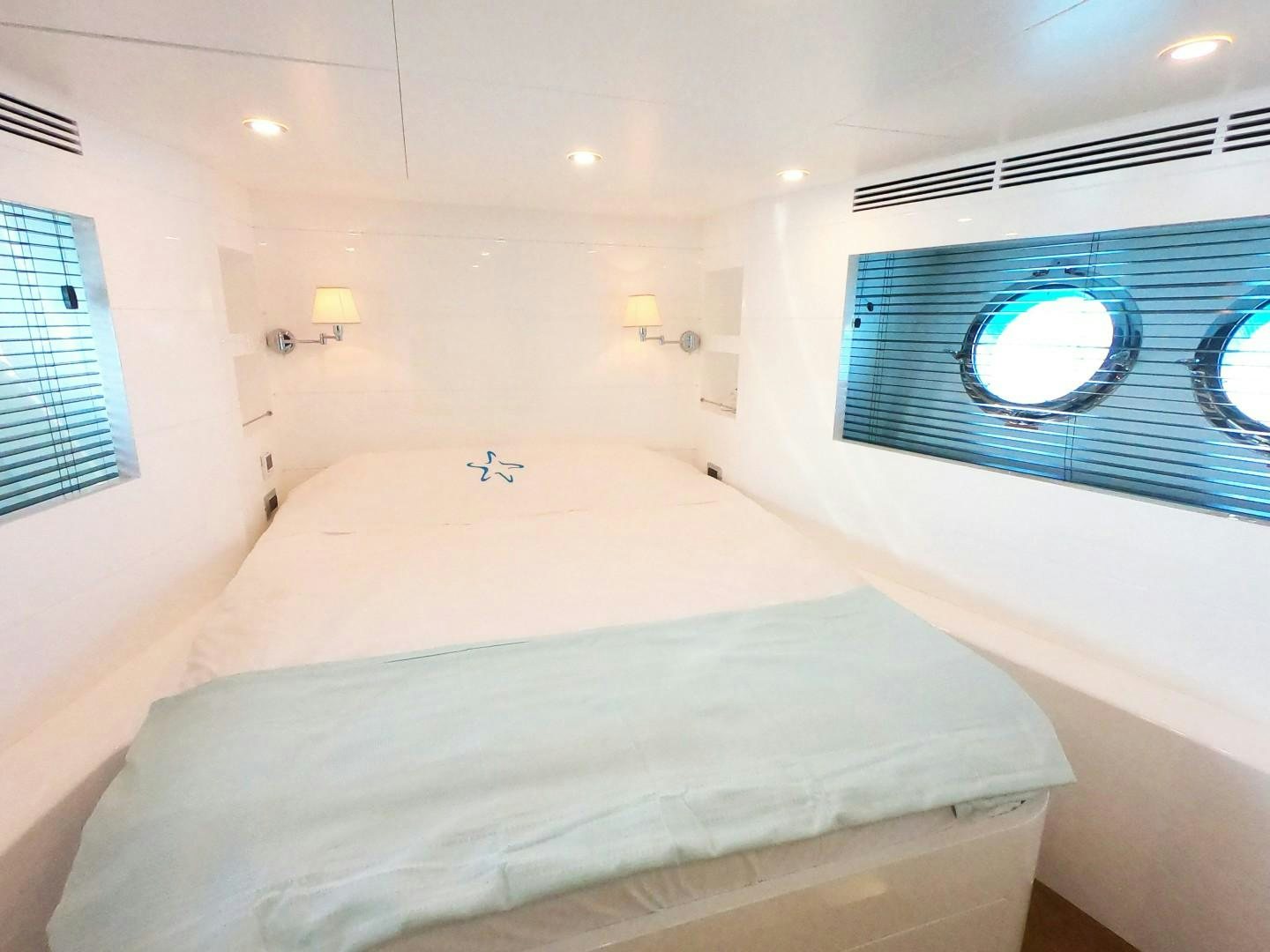 a room with a bed and a window aboard MUZO'S 20 Yacht for Sale