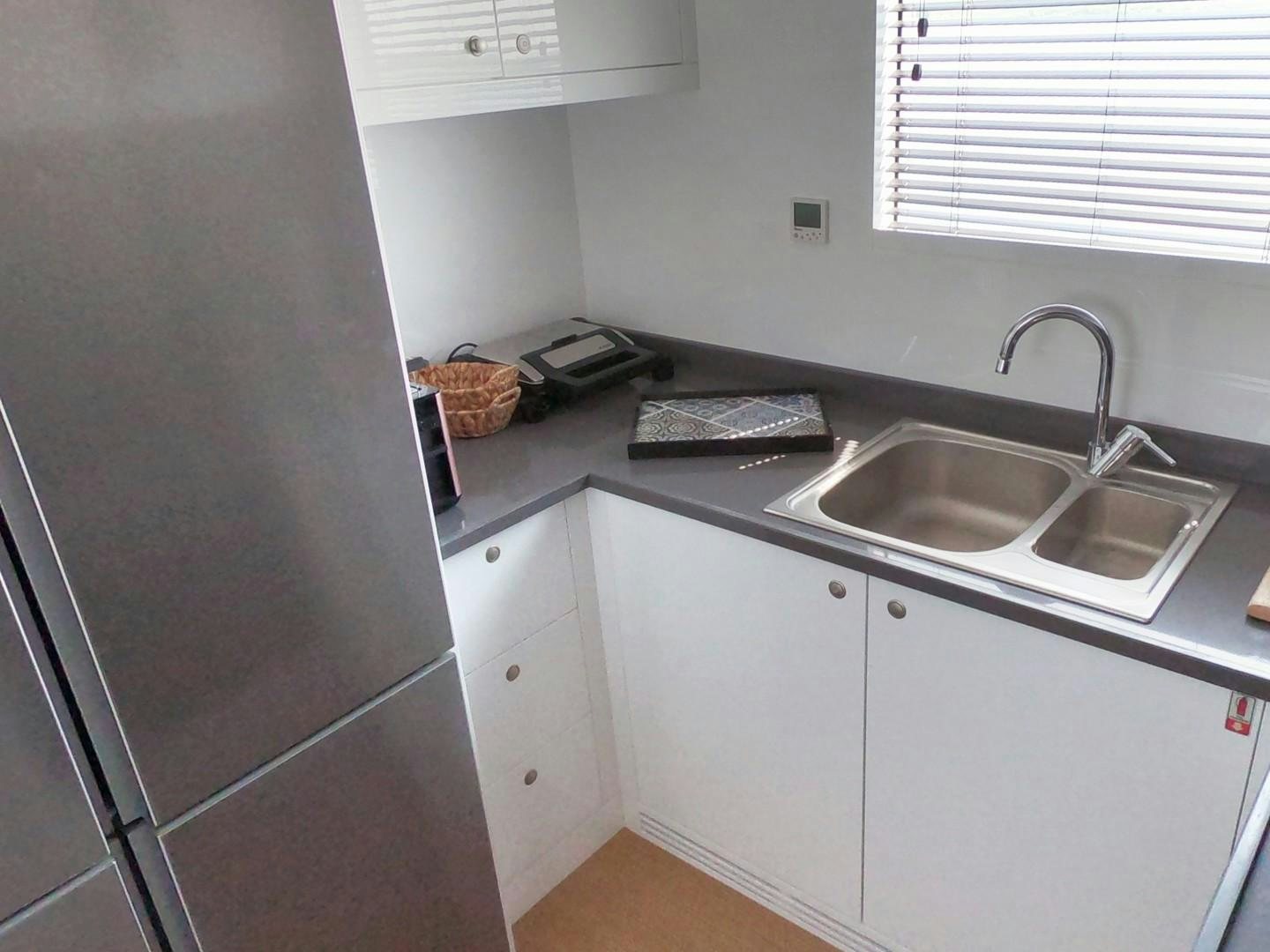 a kitchen with a sink and a shelf aboard MUZO'S 20 Yacht for Sale