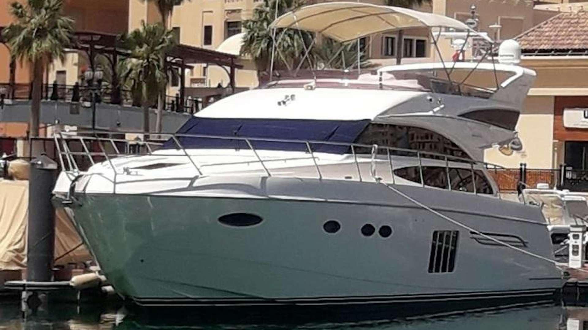 a white yacht in a harbor aboard P64 Yacht for Sale