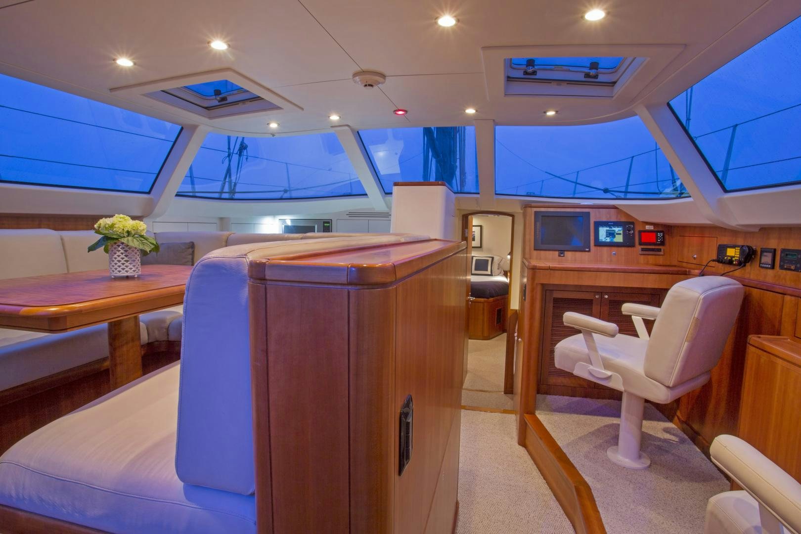 a room with a desk and chairs aboard prevail Yacht for Sale