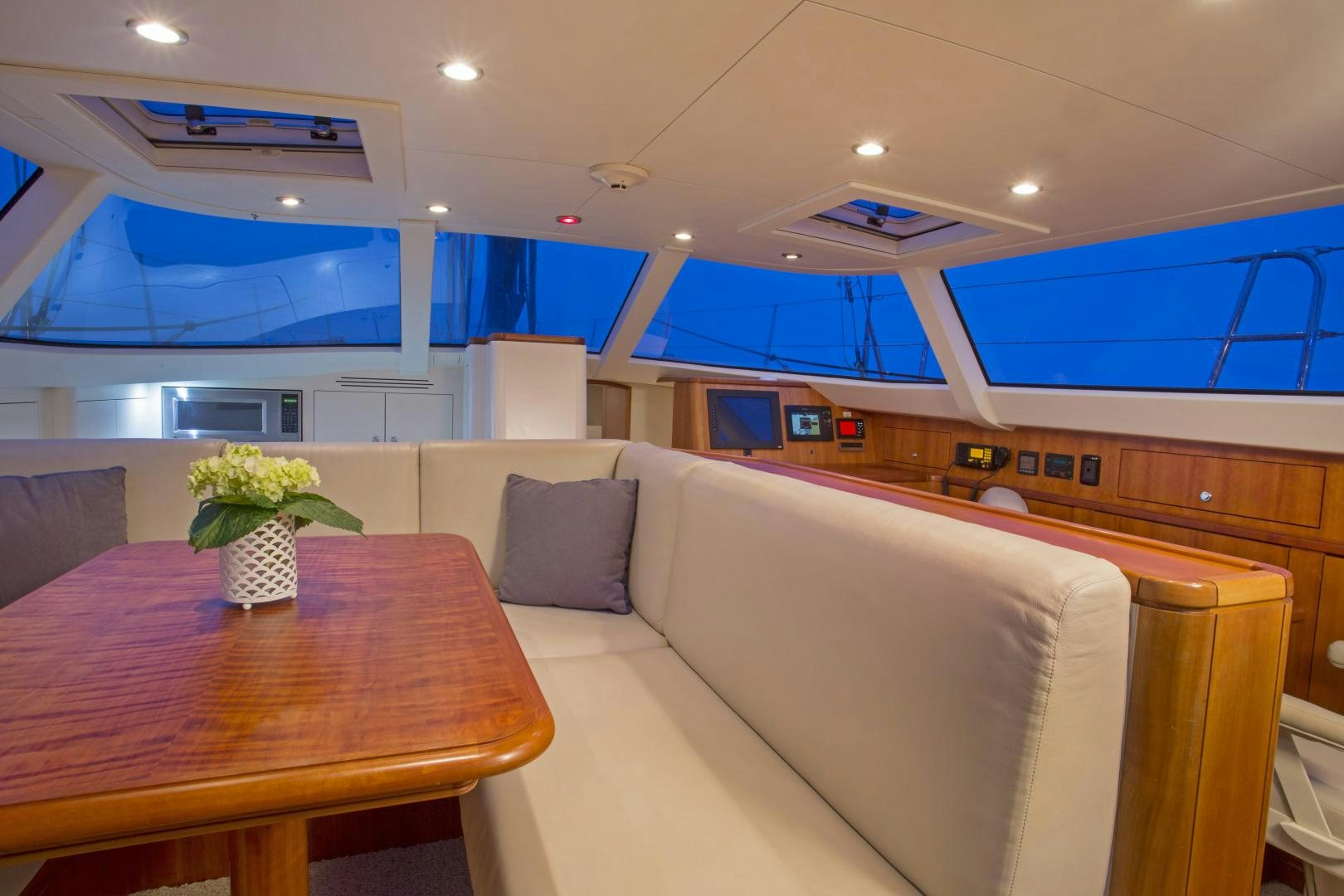 a room with a table and chairs aboard prevail Yacht for Sale