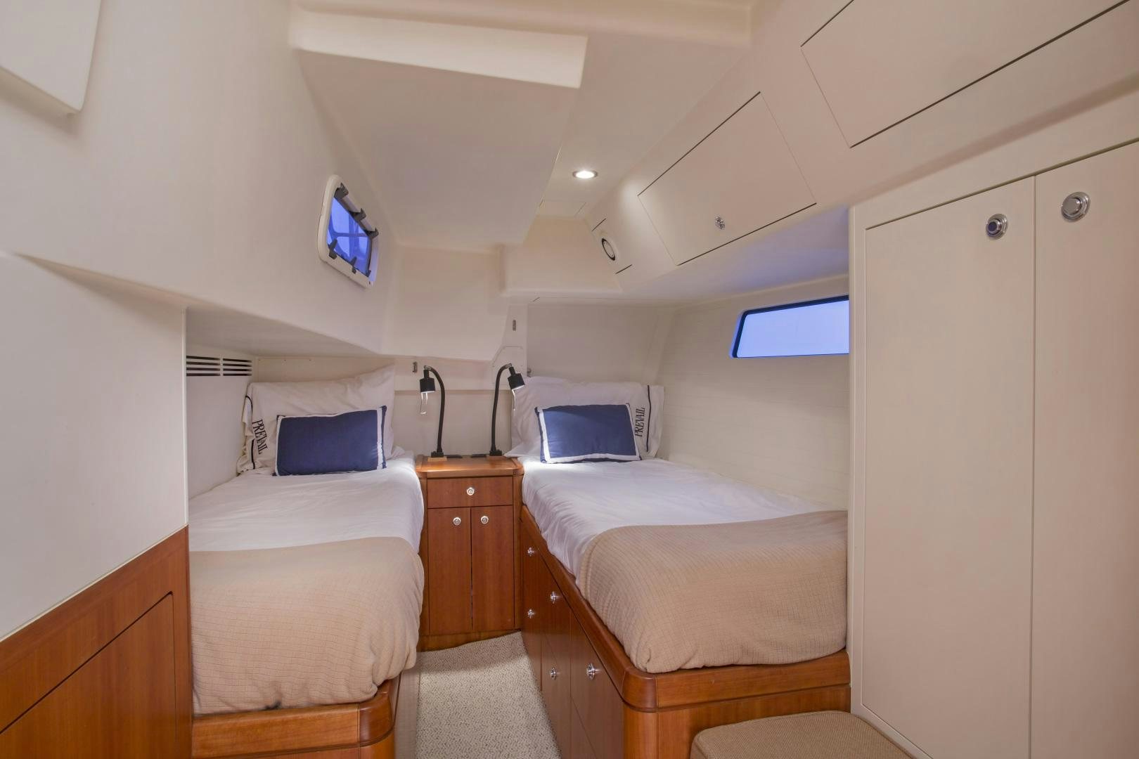 a room with two beds aboard prevail Yacht for Sale