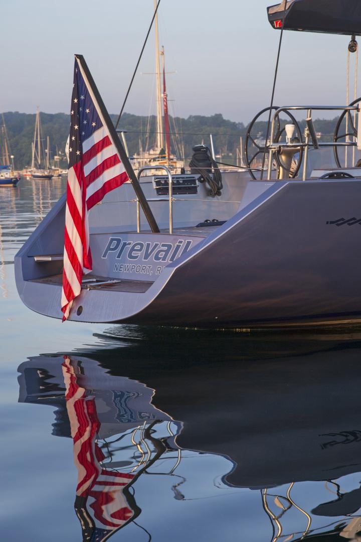 a boat with a flag on it aboard prevail Yacht for Sale