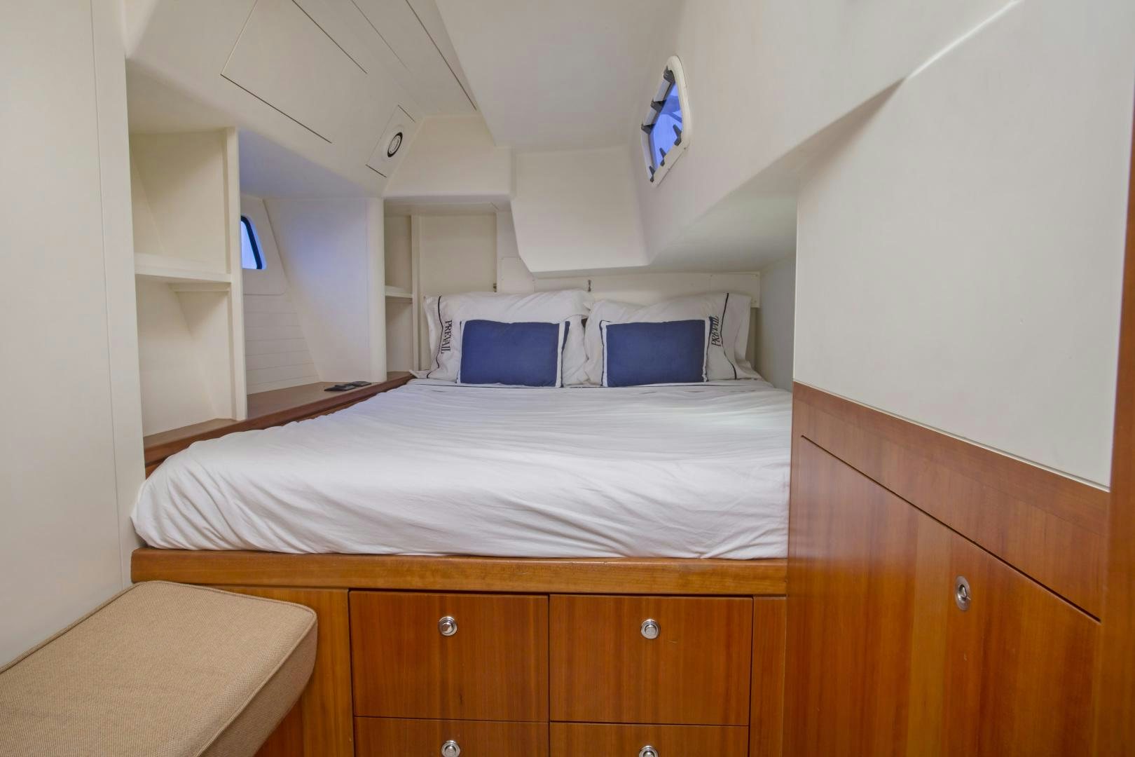 a bed with a white bed spread aboard prevail Yacht for Sale