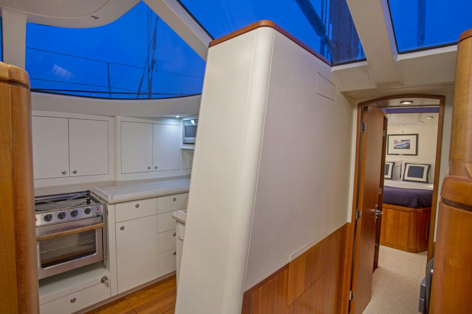 a kitchen with white cabinets aboard prevail Yacht for Sale