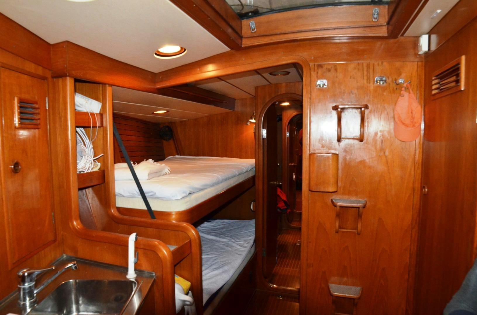a bathroom with a sink and a bed aboard blue magic Yacht for Sale