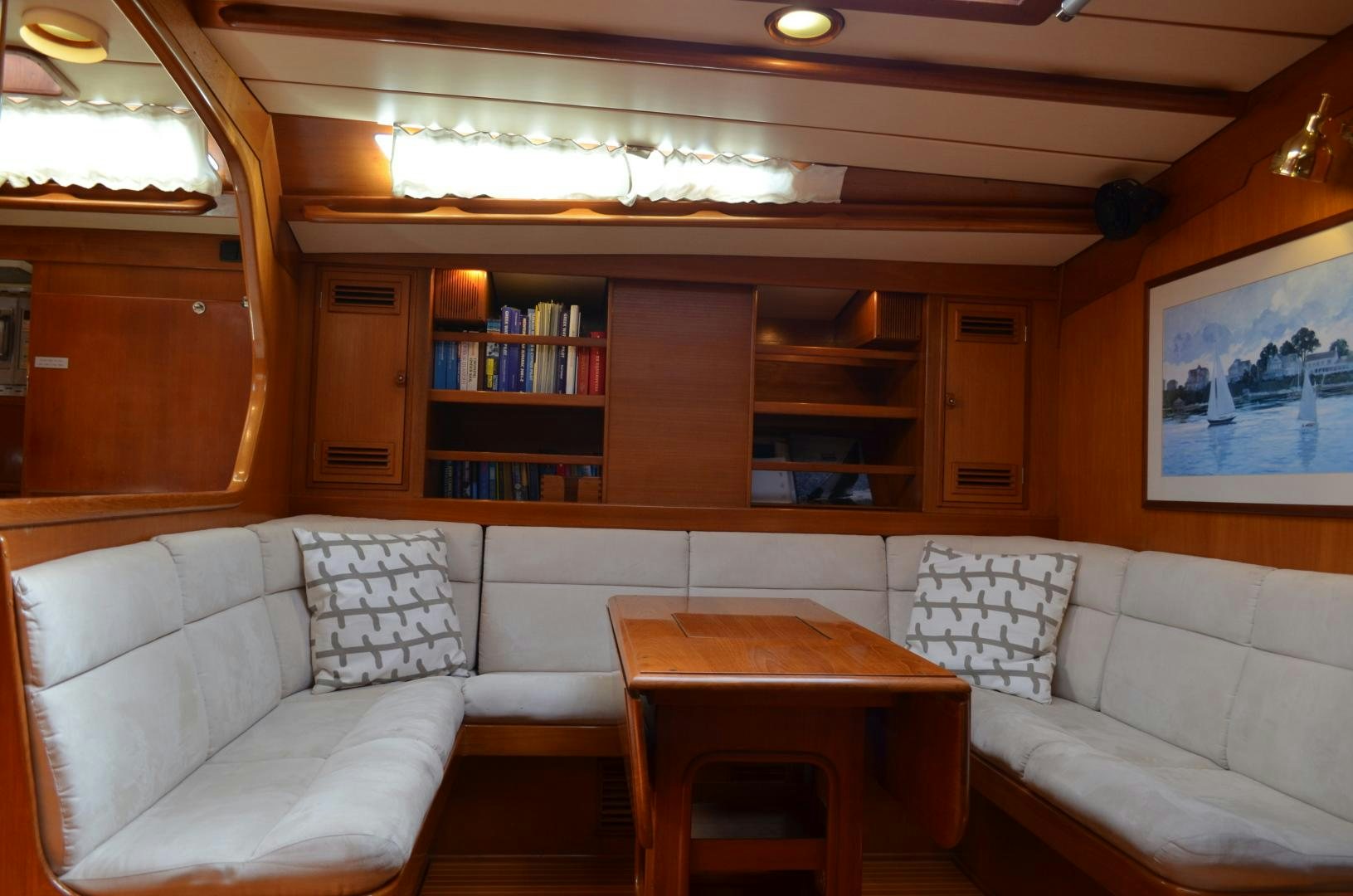 a living room with a white couch and a table aboard blue magic Yacht for Sale