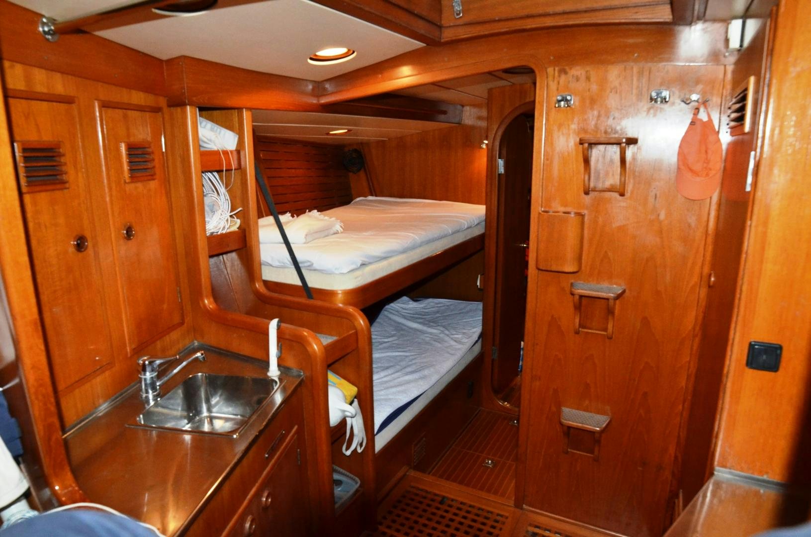 a bathroom with a sink and a bed aboard blue magic Yacht for Sale