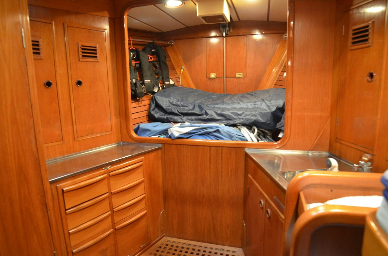 a bathroom with a sink and a bed aboard blue magic Yacht for Sale