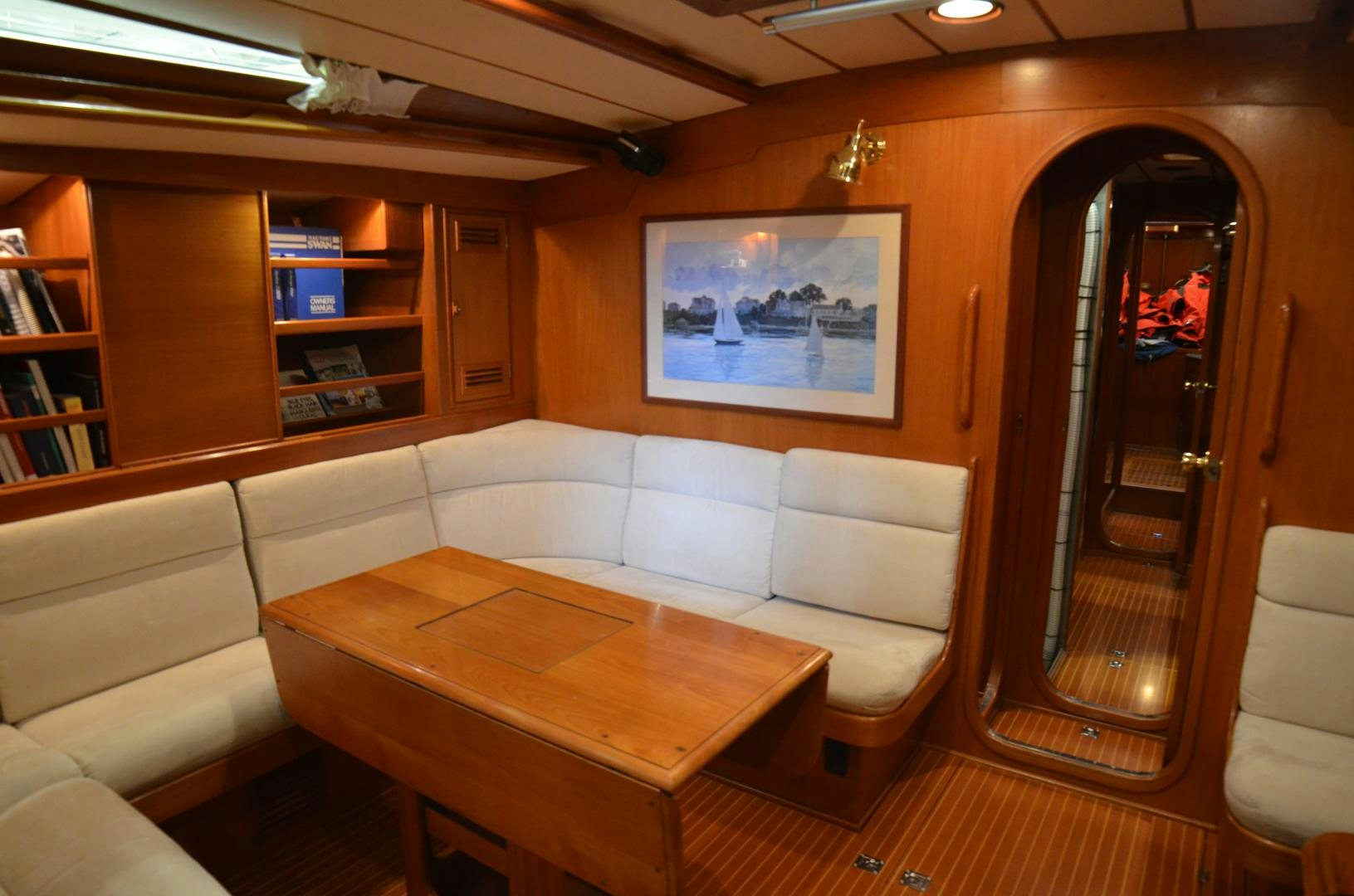 a living room with a couch and a table aboard blue magic Yacht for Sale