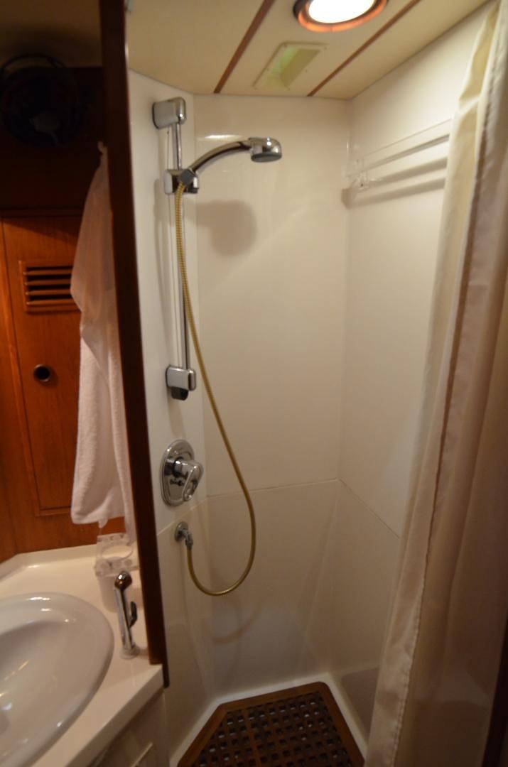 a bathroom with a shower and a sink aboard blue magic Yacht for Sale