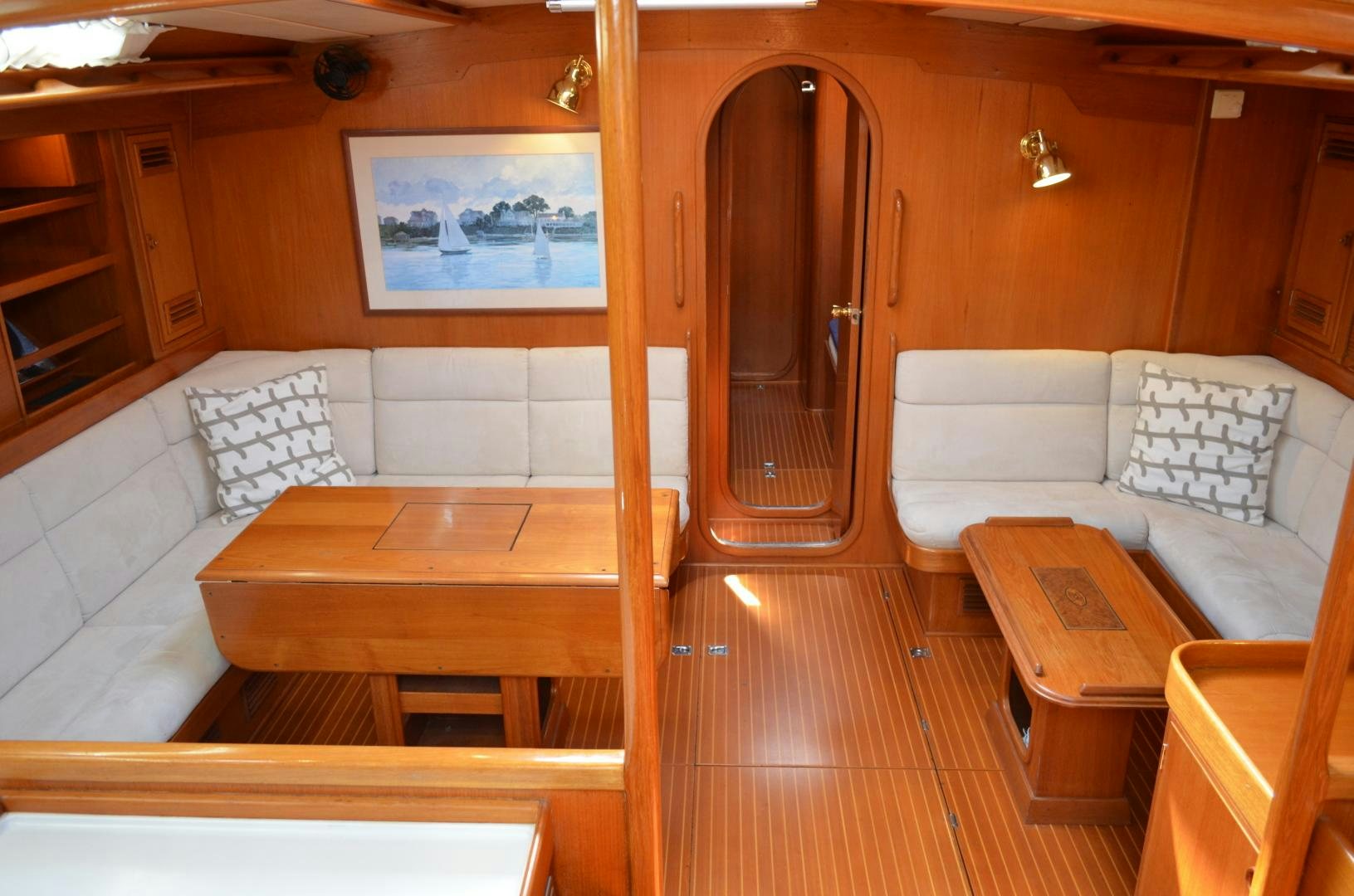 a room with a couch and a table aboard blue magic Yacht for Sale