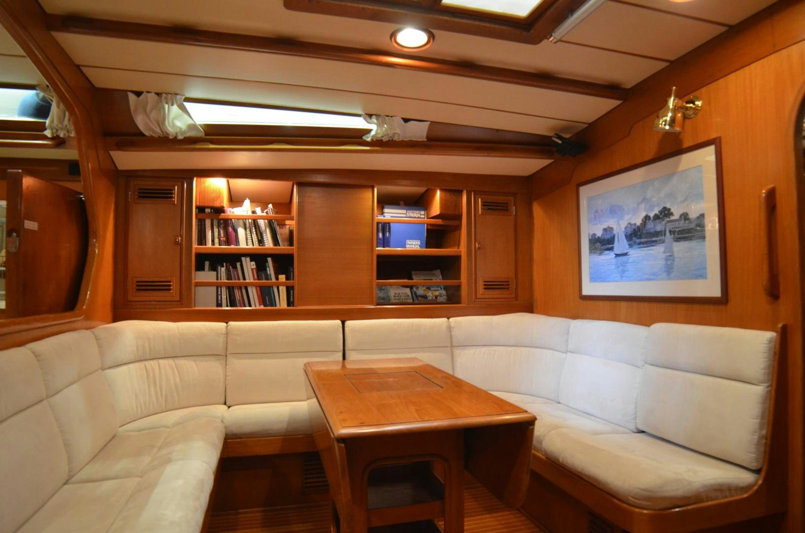 a living room with a couch and a table aboard blue magic Yacht for Sale