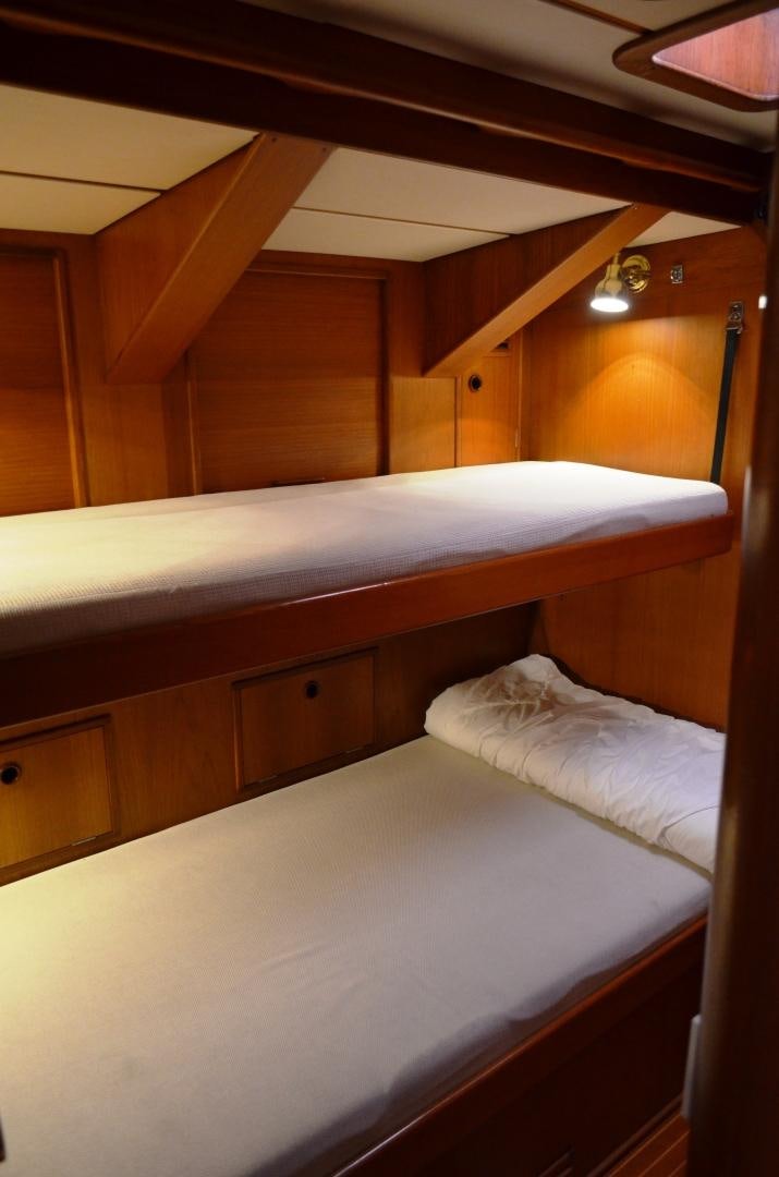 a room with bunk beds aboard blue magic Yacht for Sale