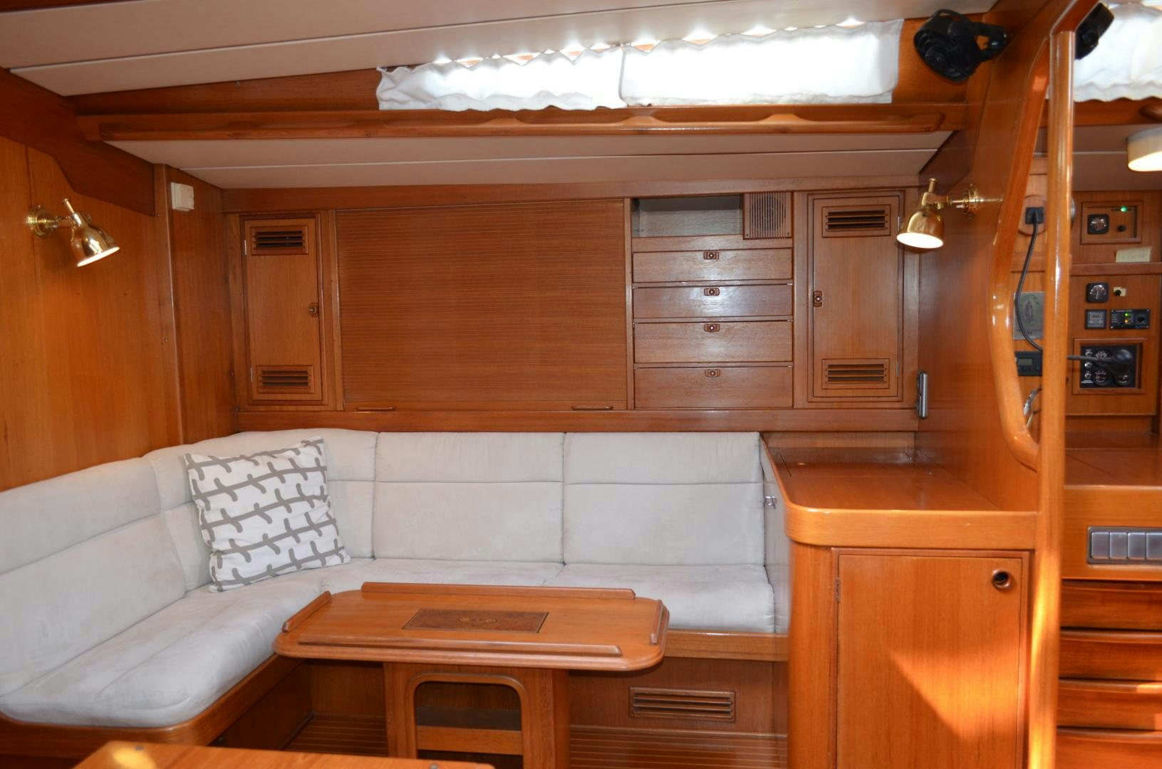 a room with a couch and a table aboard blue magic Yacht for Sale