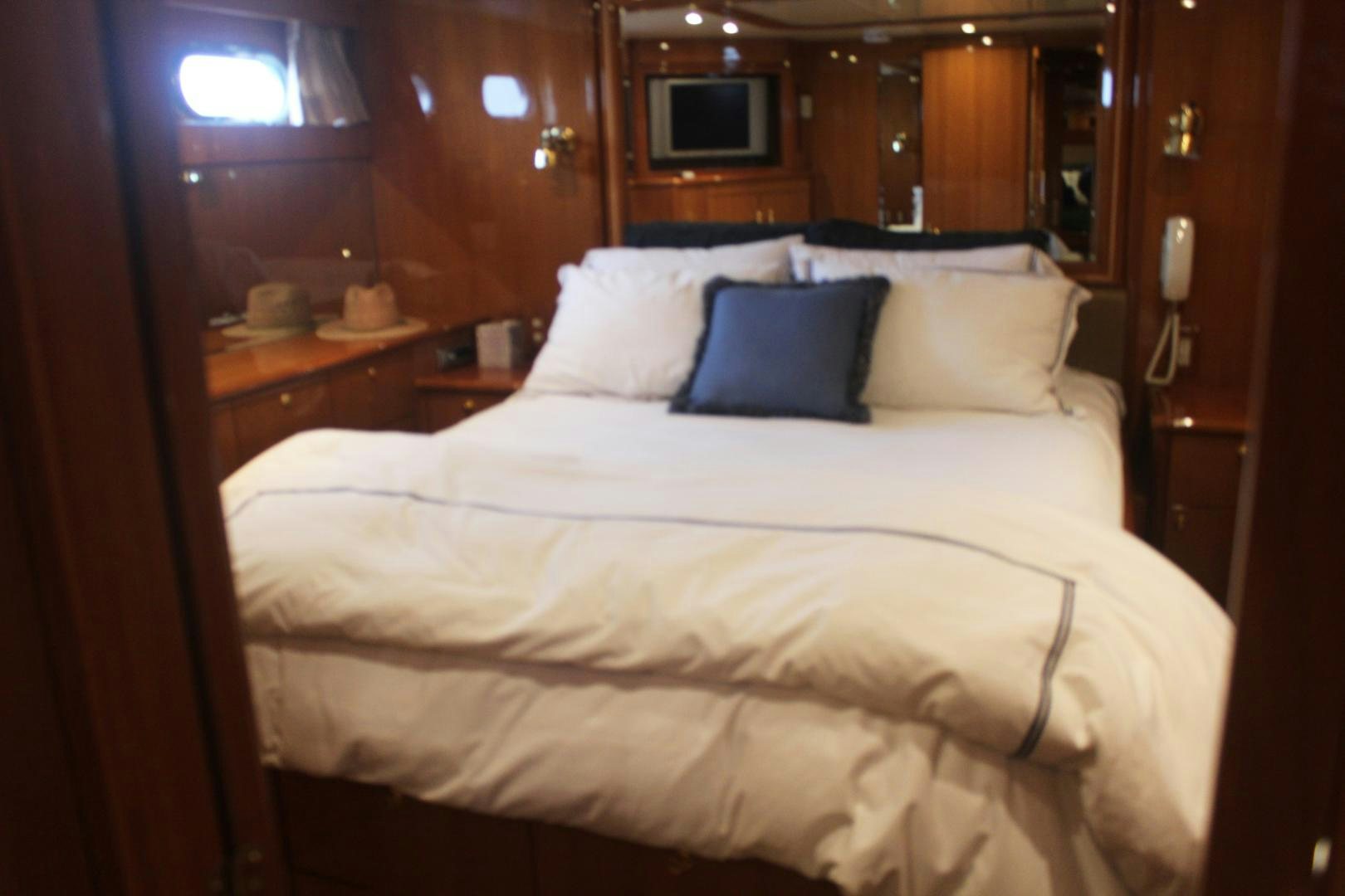 a bed with white sheets aboard LADY CYNTHIA Yacht for Sale